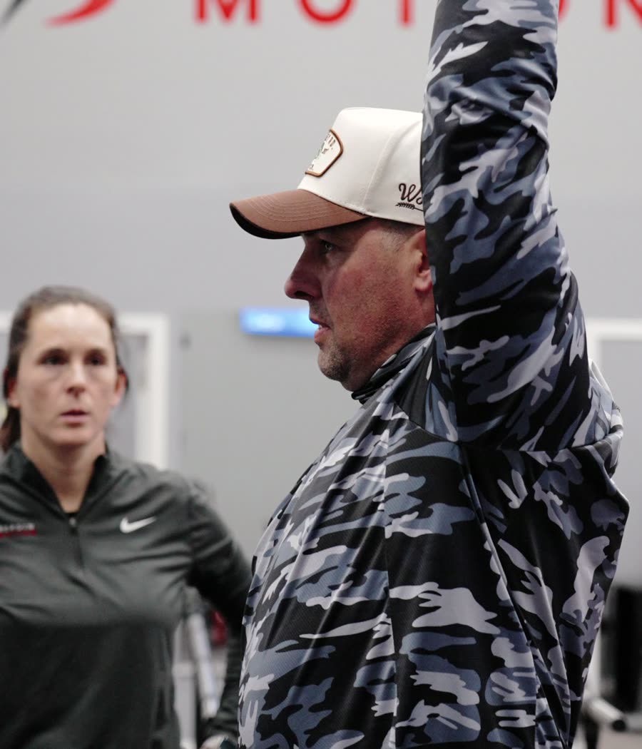 A Bergin Motion therapist coaching a client through an overhead exercise