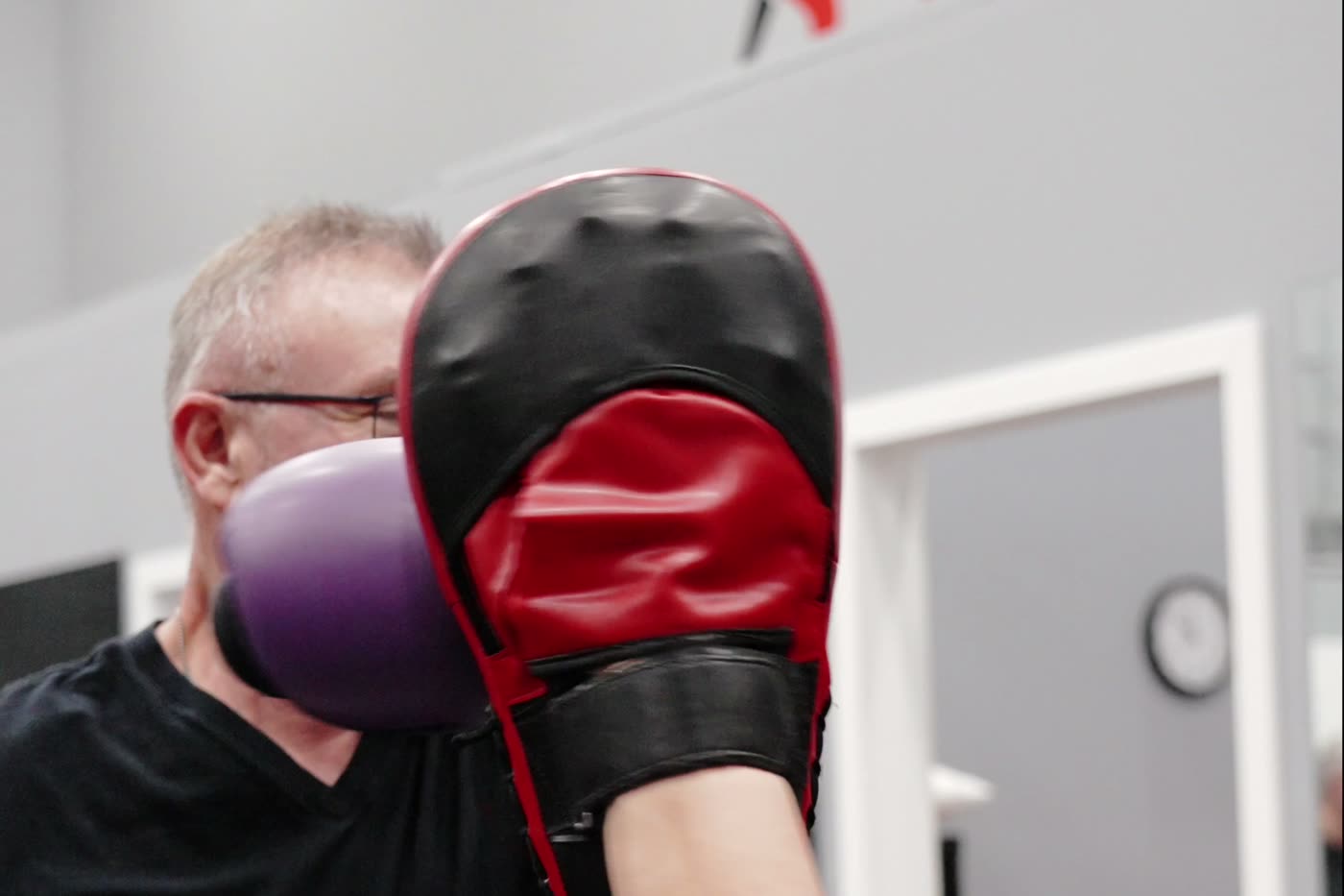 A participant working the pads during non-contact boxing for Parkinson's